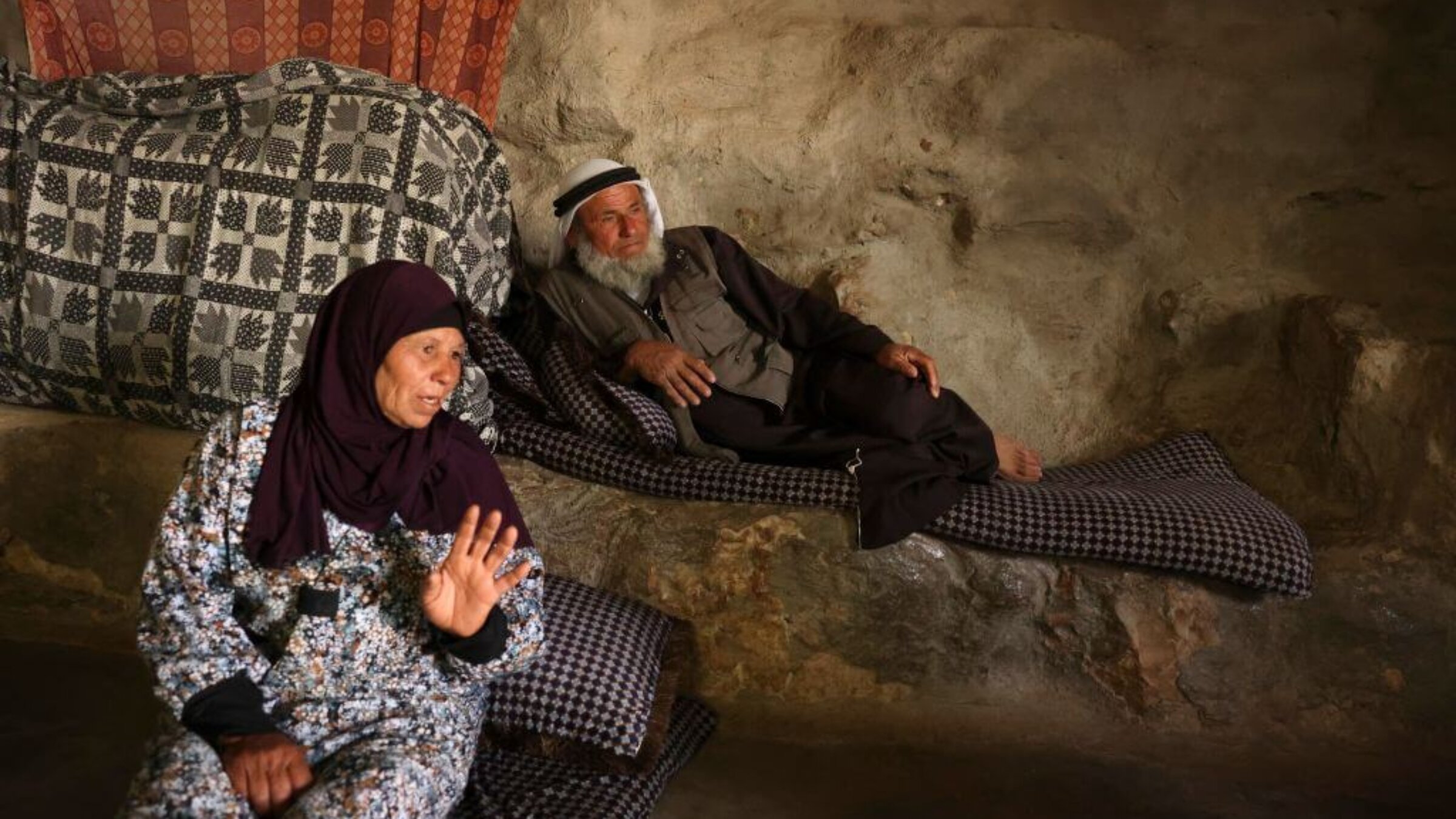 Ali Mohammed Jabbareen, right, sits at his family house in the Palestinian village of Jinba, part of the Masafer Yatta area in the Israeli-occupied West Bank, on May 9, 2022, following an Israeli High Court decision that approved the eviction of roughly 1,000 Palestinian villagers to make way for a military training zone.