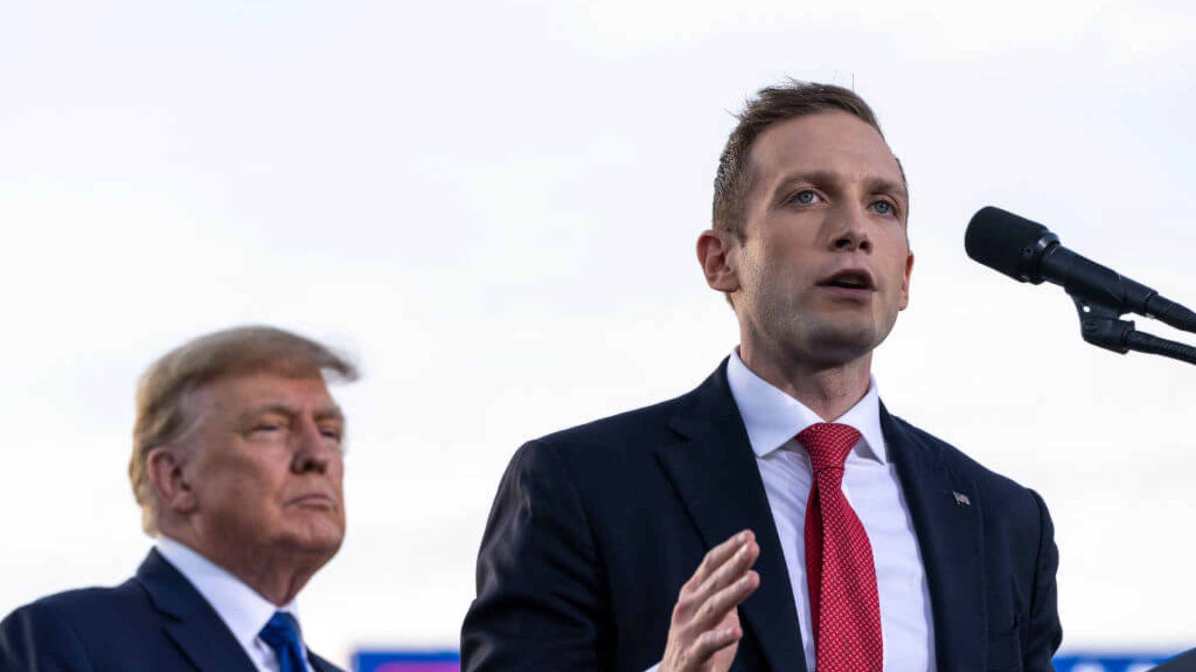 (L-R) Former U.S. President Donald Trump listens as Max Miller, Republican candidate for Ohio's 7th congressional district, speaks during a rally hosted by the former president at the Delaware County Fairgrounds on April 23, 2022 in Delaware, Ohio.