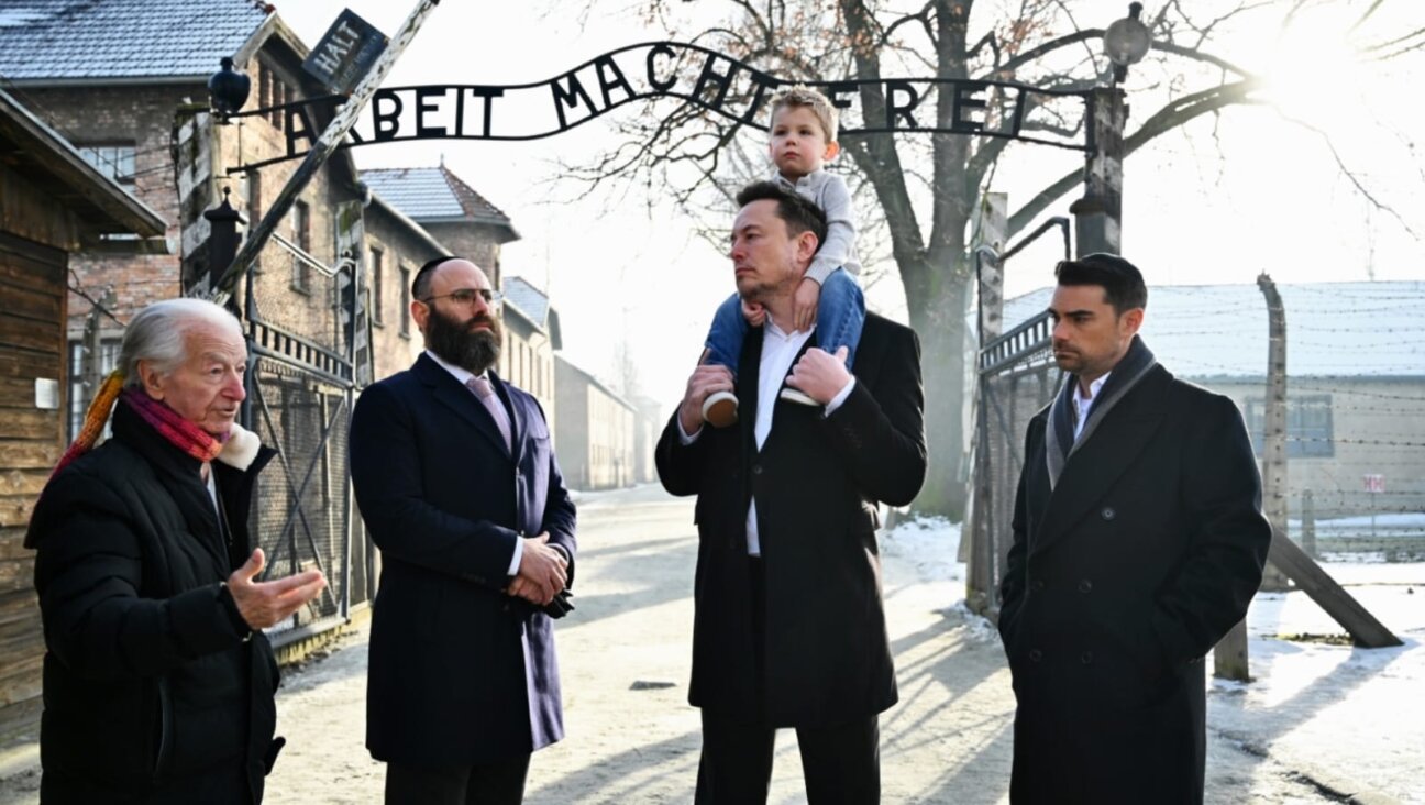 Holocaust survivor Gidon Lev, European Jewish Association Chairman Rabbi Menachem Margolin, Elon Musk with his son, and Ben Shapiro at the entrance of Auschwitz, Jan. 22, 2024.