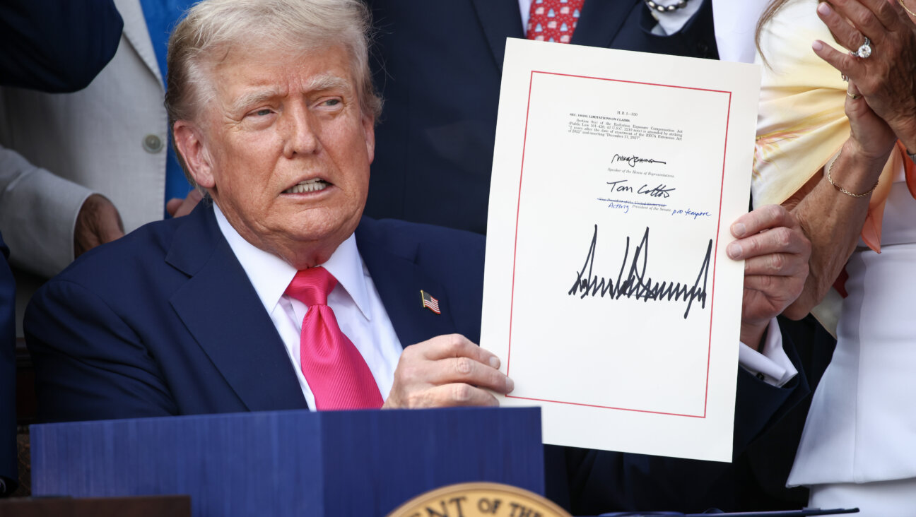 President Donald Trump signs the One Big Beautiful Bill Act into law on July 4.